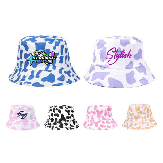 A collection of bucket hats featuring cow print in blue, white, black, pink, and orange, with various logos.