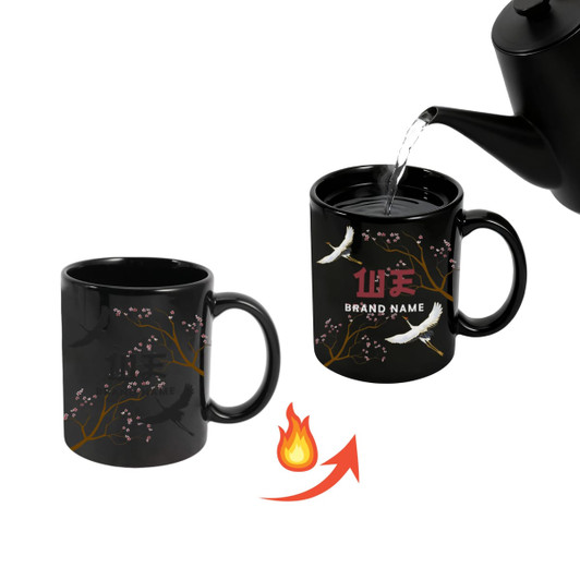 A heat-sensitive colour changing mug in black, featuring floral designs, with hot water being poured into it.