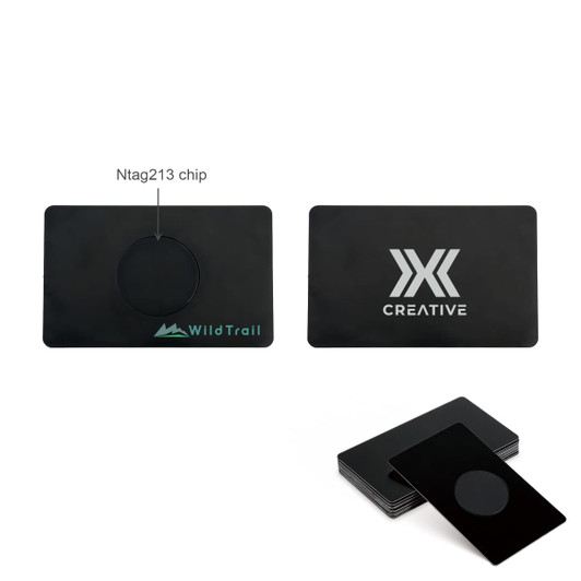 A black metal business card featuring a central NFC chip and branding on both sides.