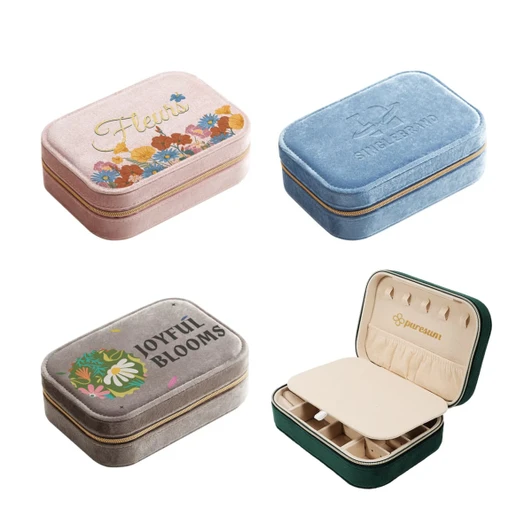 A collection of velvet jewellery boxes in pink, blue, grey, and green, featuring compartments and branding.