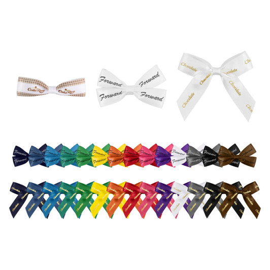 A variety of adhesive bows in multiple colours, including white, black, blue, and red, arranged in rows.