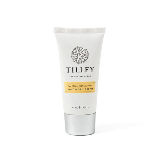 A hand and nail cream tube in white and silver, featuring a floral logo and a yellow label.