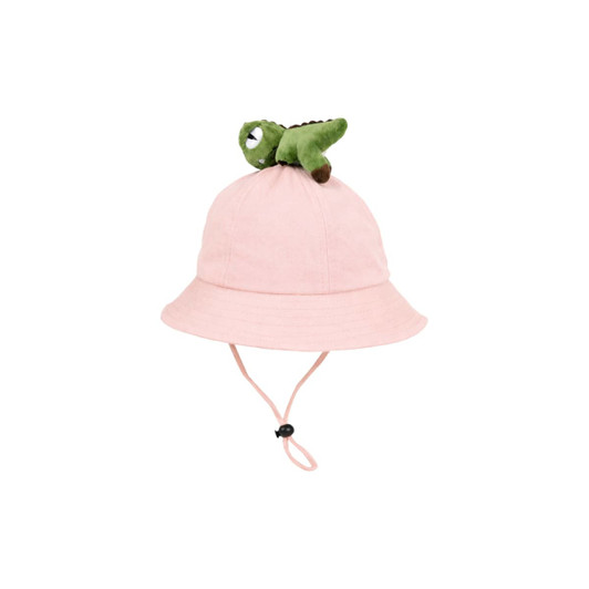 A pink bucket hat with a green dinosaur plush toy on top and an adjustable chin strap.