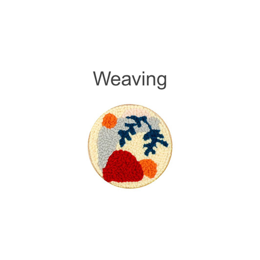 A round punch needle coaster kit featuring a colourful design in shades of grey, red, blue, and orange, with a wooden border.