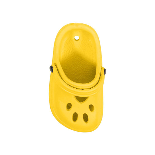A yellow paw-shaped clog shoe fridge magnet with ventilation holes and a black button detail.