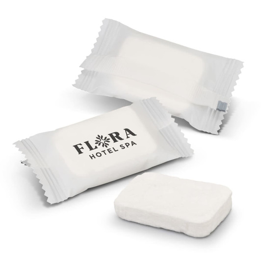 Compressed towels in white packaging, with an accompanying towel in a rectangular shape. One package features a logo.