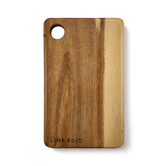 An acacia serving board in warm brown tones, featuring a circular cut-out and a logo on the side.