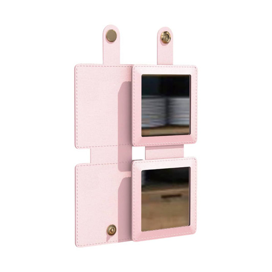 A square folding pocket mirror in a soft pink finish, featuring two reflective surfaces and a snap closure.