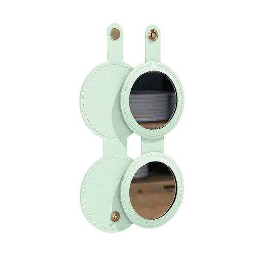 A round folding pocket mirror in mint green with two reflective surfaces and a logo on the side.