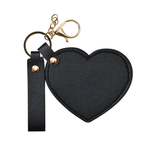 A heart-shaped black compact mirror with a keychain attachment and a gold clasp.