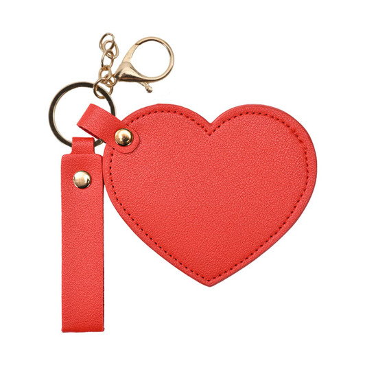 A heart-shaped compact mirror in bright red, featuring a keychain and a clasp for easy attachment.