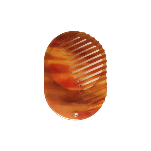 A portable acetate hair comb in warm amber tones, featuring a built-in mirror. It has a sleek, rounded design.