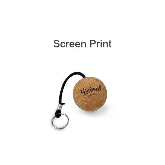 A cork keyring featuring a round design with a black attachment strap and a logo. The keyring has a natural cork finish.