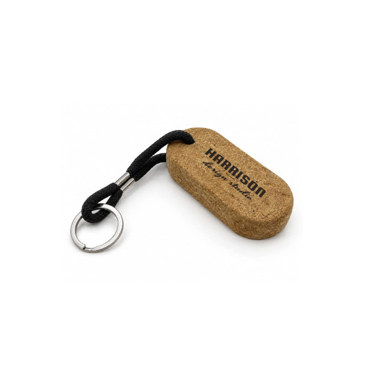 A cork keyring with a black strap and metal keyring attachment, featuring a logo on the cork surface.