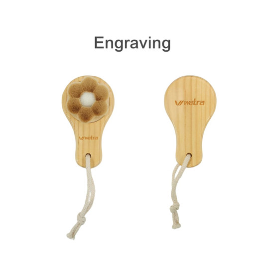 A flower-shaped facial cleansing brush with a wooden handle and a natural bristle head, featuring a hanging loop.