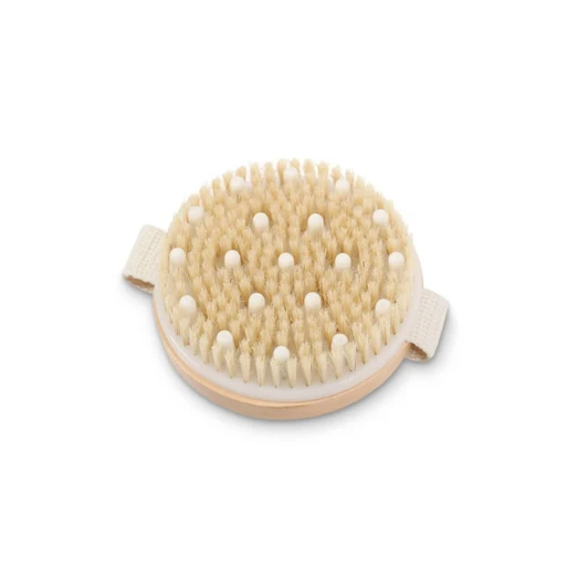 An exfoliating brush with soft beige bristles and white massage nodules, featuring a light wood base and handle.