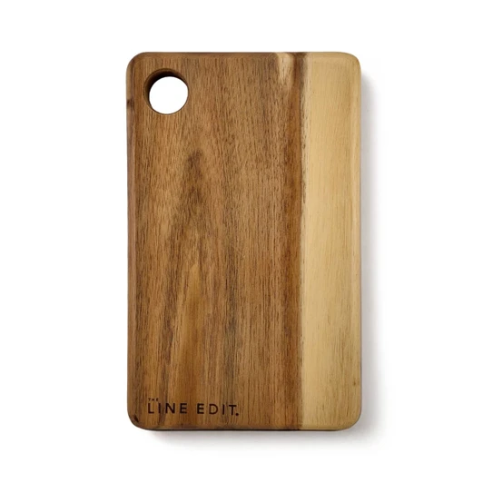 An acacia serving board in warm brown tones, featuring a circular cut-out and a logo on the side.