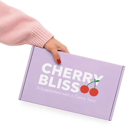 A hand holding a purple box with a locking lid, featuring a logo and cherry graphic.