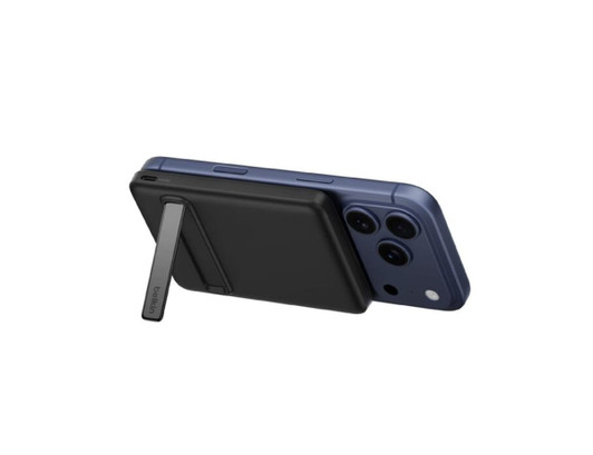 A black magnetic power bank attached to a blue smartphone, featuring a stand on the back. It has branding visible.