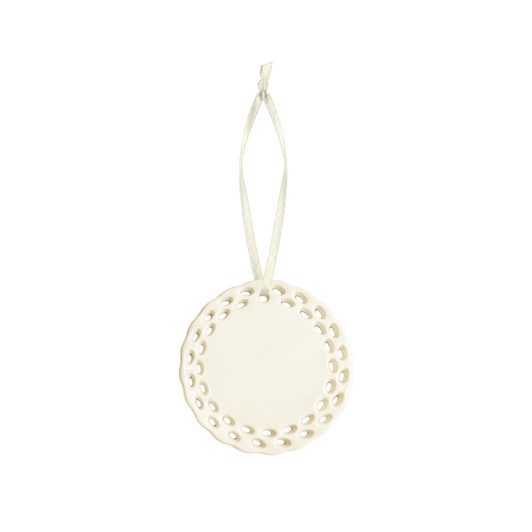 A ceramic ornament in white with a decorative perforated edge and a hanging ribbon.