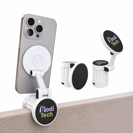 A white phone holder with a black attachment, displaying a logo, mounted on a smartphone and a tabletop.