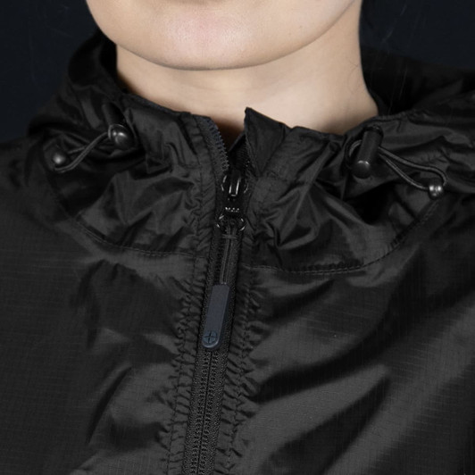 A black windbreaker jacket featuring a zip front and adjustable drawcord hood, with a logo.