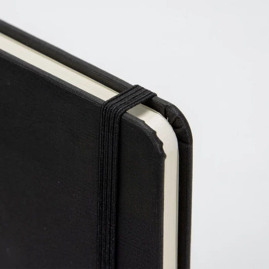 A4 daily diary in black with an elastic band closure and rounded corners. Features a textured cover and plain pages.