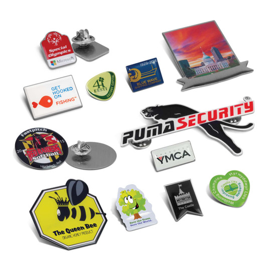 A collection of colourful lapel badges in various shapes, including animal, logo, and event-themed designs, with pins.