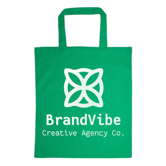 A green cotton tote bag with a large white logo featuring a flower design and the text "BrandVibe Creative Agency Co."