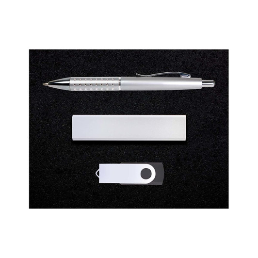 A silver pen, a silver USB drive, and a silver cardholder arranged on a black surface.