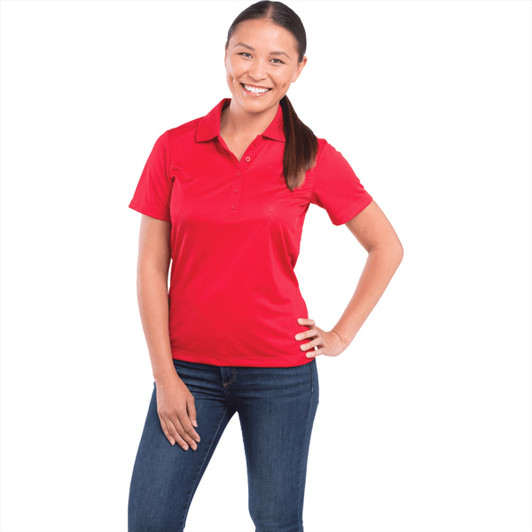 A red women's polo shirt with short sleeves and a collar, featuring a logo.