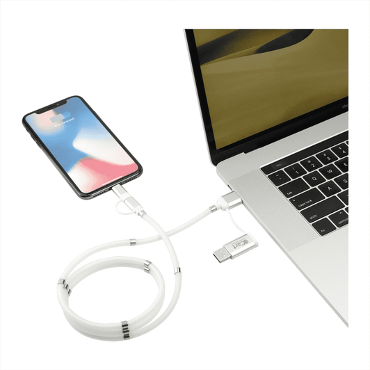 A white 5-in-1 charging cable with a magnetic wrap, connecting a phone to a laptop. The cable features a sleek design.