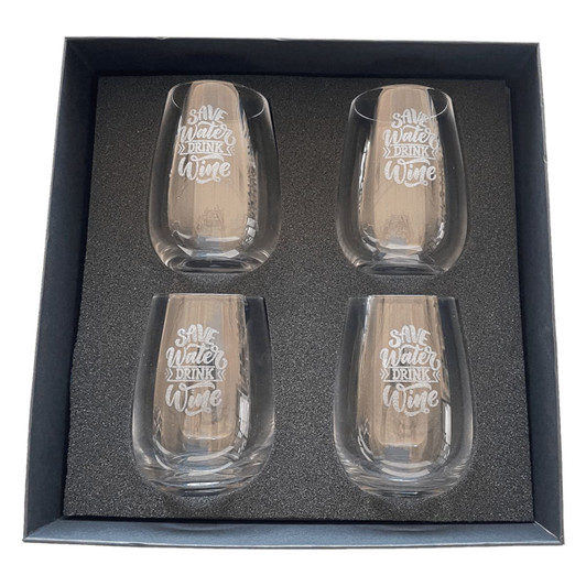 A set of four clear glass wine glasses with etched white text, presented in a black gift box.