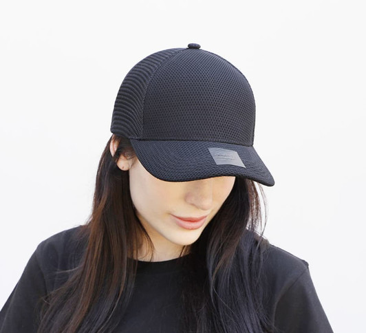 A black nylon and mesh cap with a structured design and a logo patch at the front.