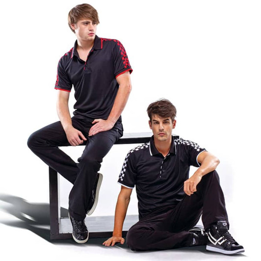 Two men are wearing black polo shirts with red and checkered accents, sitting on a platform.