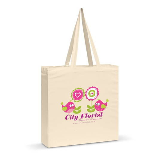 A cream cotton shoulder tote bag with a colourful floral and bird design, featuring a logo.