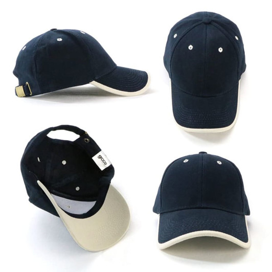  Navy cap with a cream brim and a branding tag, featuring stitched ventilation holes and an adjustable strap at the back.