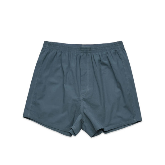 Boxer shorts in a teal colour, featuring an elastic waistband and a simple design. The item has a brand logo.