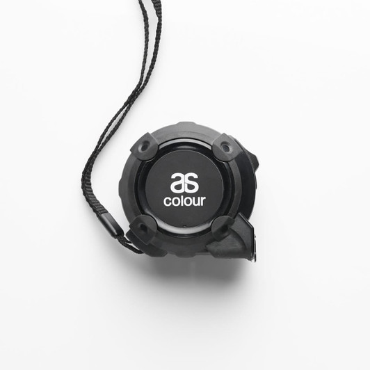 A black ASC tape measure with a lanyard, featuring a circular design and a logo on the front.