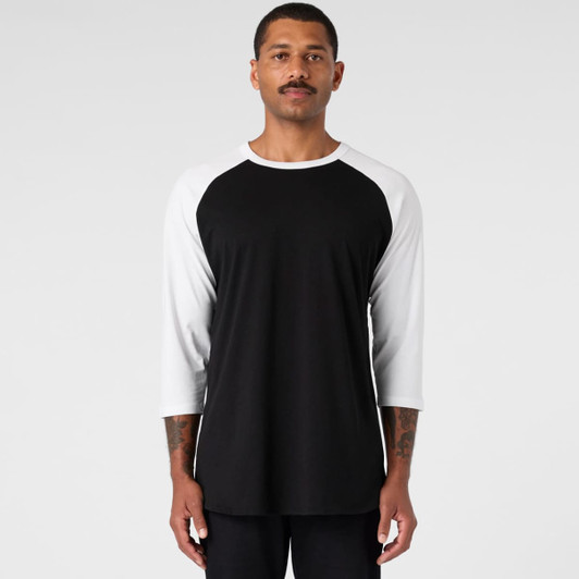 A black and white Raglan Tee featuring a crew neck and three-quarter sleeves, with a logo present.