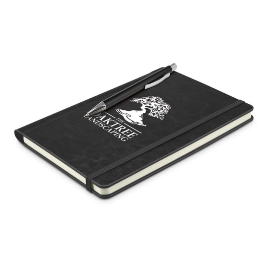 A black notebook with an elastic band and a pen resting on top, featuring a logo on the cover.
