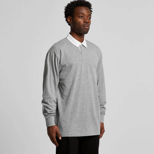 A grey rugby jersey featuring long sleeves and a white collar, with a logo on the chest.