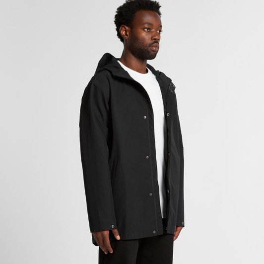A black rain jacket with a hood, featuring a front zip and snap closures, displayed on a model.