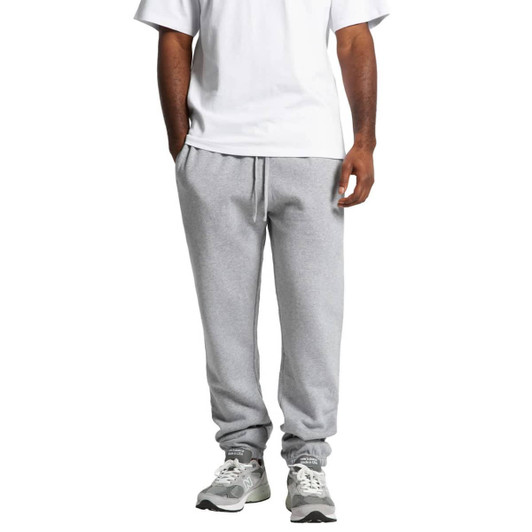 Grey track pants with a relaxed fit, featuring an elastic waistband and cuffs, paired with a plain white t-shirt.