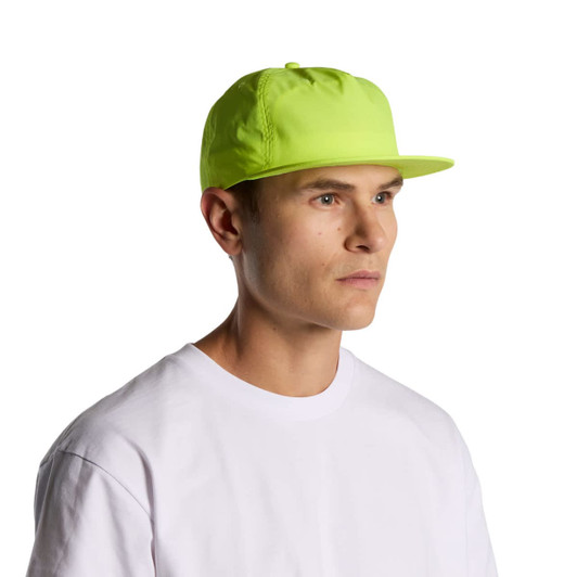 A vibrant yellow cap worn by a model, featuring a flat brim and a logo. The cap is designed for outdoor use.