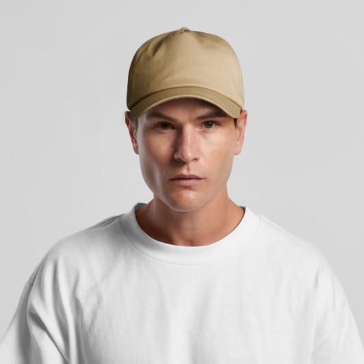 A beige cap is displayed on a model wearing a plain white t-shirt, featuring a logo on the front.