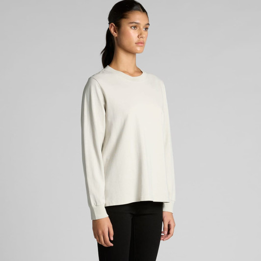 A long-sleeve tee in a faded cream colour, featuring a crew neckline and a relaxed fit. It has a logo on the front.