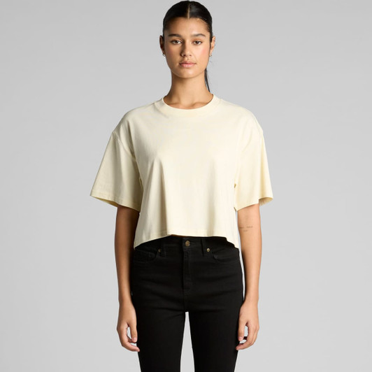 A cropped tee in a soft yellow hue, featuring short sleeves and a relaxed fit, with a logo on the front.