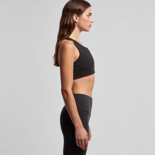 A black sports crop top featuring a sleek design and a fitted silhouette, modelled on a woman from the side.