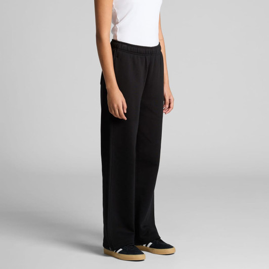 A pair of black cuffless track pants with an elastic waistband, displayed on a model standing upright.